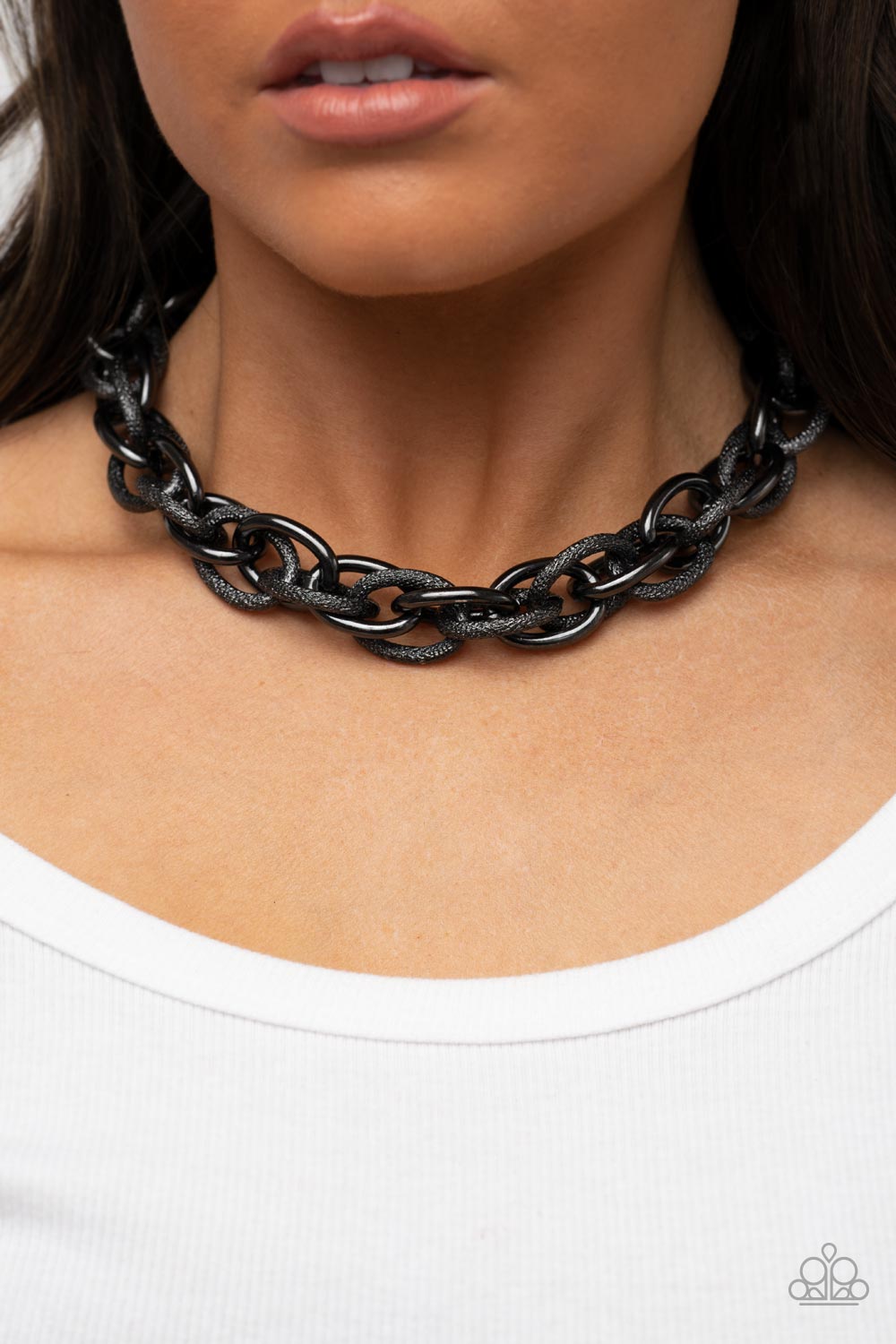 Paparazzi Accessories License to Chill - Black Featuring smooth and glitzy textured finishes, two oversized gunmetal chains interlock into a single chain below the collar for an intense industrial display. Features an adjustable clasp closure. Sold as one