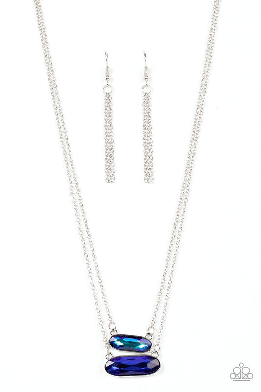 Paparazzi Accessories Double Bubble Burst - Blue Featuring faceted oblong cuts, a UV blue gem is delicately suspended above a slightly larger glittery blue gem below the collar for a stellar double-stacked display. Features an adjustable clasp closure. So