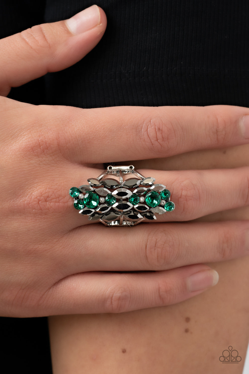 Paparazzi Accessories Smoky Smolder - Green A cascade of dainty white, marquise cut hematite, and round green rhinestones tumble down the finger, coalescing into a smoldering centerpiece. Features a stretchy band for a flexible fit. Sold as one individual