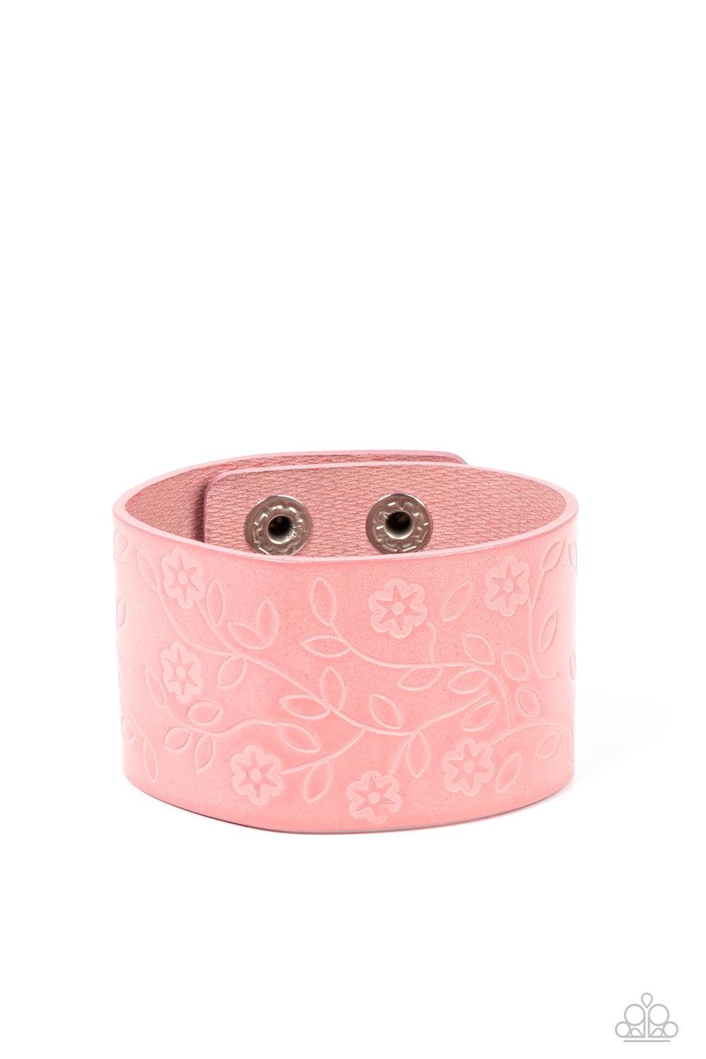 Paparazzi Accessories Rosy Wrap Up - Pink A flowery and leafy motif blooms across the front of a distressed pink leather band, resulting in a rustic floral centerpiece around the wrist. Features an adjustable snap closure. Sold as one individual bracelet.
