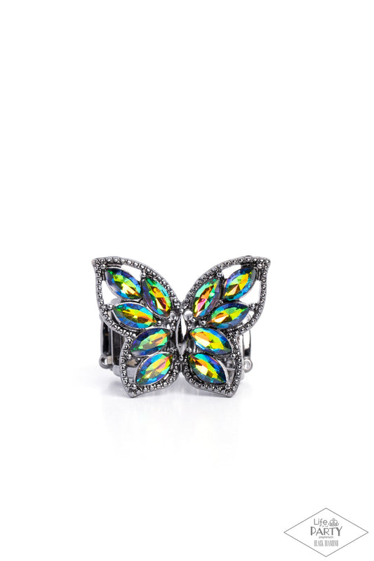 Paparazzi Accessories Fluttering Fashionista - Multi The wings of a studded gunmetal butterfly have been adorned in glittery oil spill marquise rhinestones, creating a glamorous centerpiece atop the finger. Features a stretchy band for a flexible fit. Due