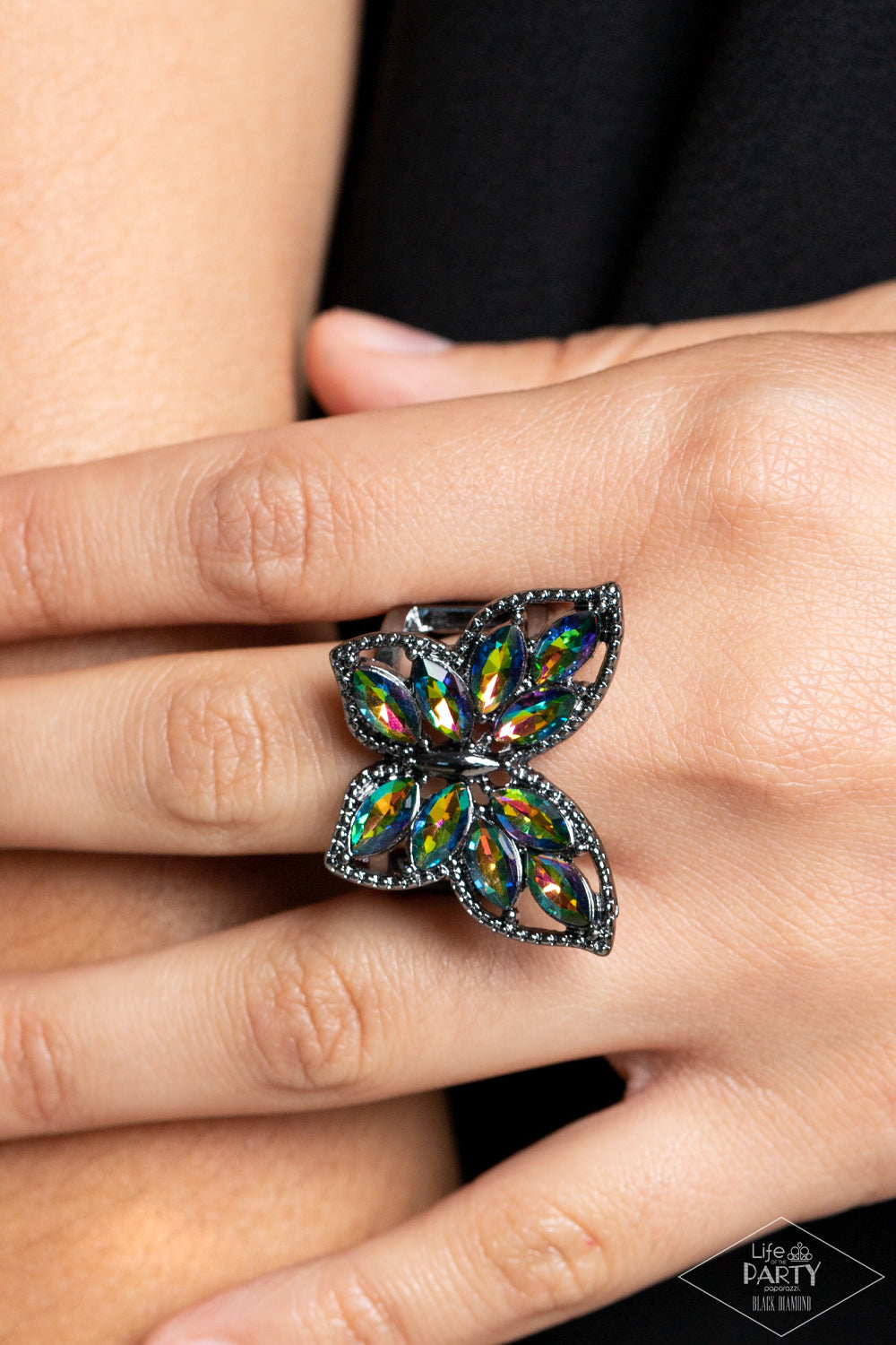 Paparazzi Accessories Fluttering Fashionista - Multi The wings of a studded gunmetal butterfly have been adorned in glittery oil spill marquise rhinestones, creating a glamorous centerpiece atop the finger. Features a stretchy band for a flexible fit. Due