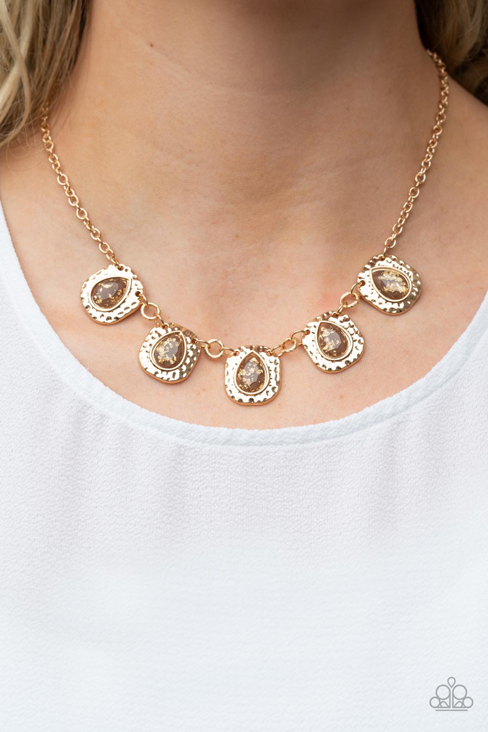 Paparazzi Accessories Mayan Masterpiece - Brown Flecked in gold foil, glassy brown teardrops are pressed into hammered gold frames that delicately link below the collar for a dash of refined shimmer. Features an adjustable clasp closure. Sold as one indiv