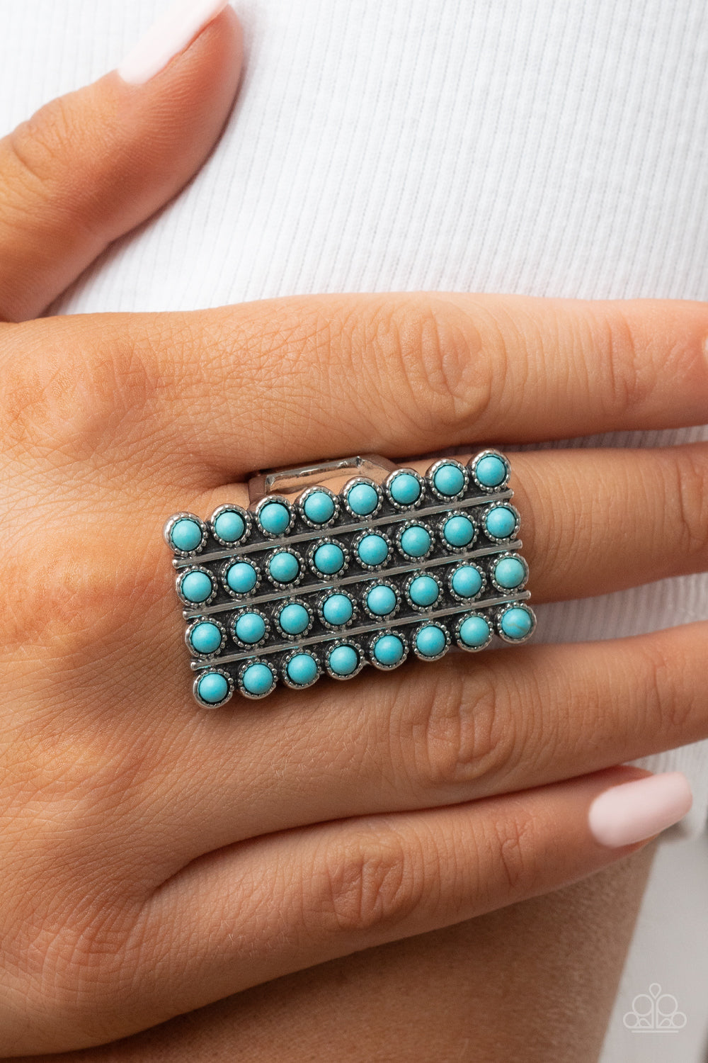 Paparazzi Accessories Pack Your SADDLEBAGS - Blue Bordered in antiqued silver studs, rows of dainty turquoise stones boldly stack up the finger across the front of an oversized rectangular silver frame for an earthy vibe atop the finger. Features a stretc