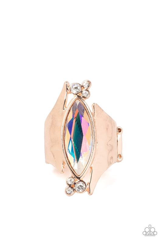 Paparazzi Accessories Planetary Paradise - Rose Gold An oversized marquise cut iridescent gem asymmetrically balances between two flared and hammered rose gold frames. Clusters of dainty white rhinestones flanks the spellbinding centerpiece for a delicate