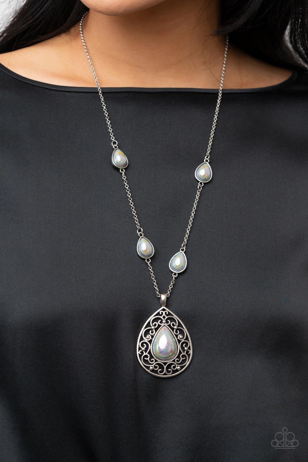 Paparazzi Accessories Magical Masquerade - Silver Brushed in an iridescent finish, a silvery teardrop bead is pressed into the center of an oversized silver teardrop frame that is bursting with vine-like filigree. Infused with matching teardrop beaded fra