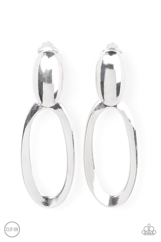 Paparazzi Accessories Pull OVAL! - Silver An asymmetrical silver oval hinges from the bottom of a spherical silver oval fitting, resulting in a radiant lure. Earring attaches to a standard clip-on fitting. Sold as one pair of clip-on earrings. Jewelry