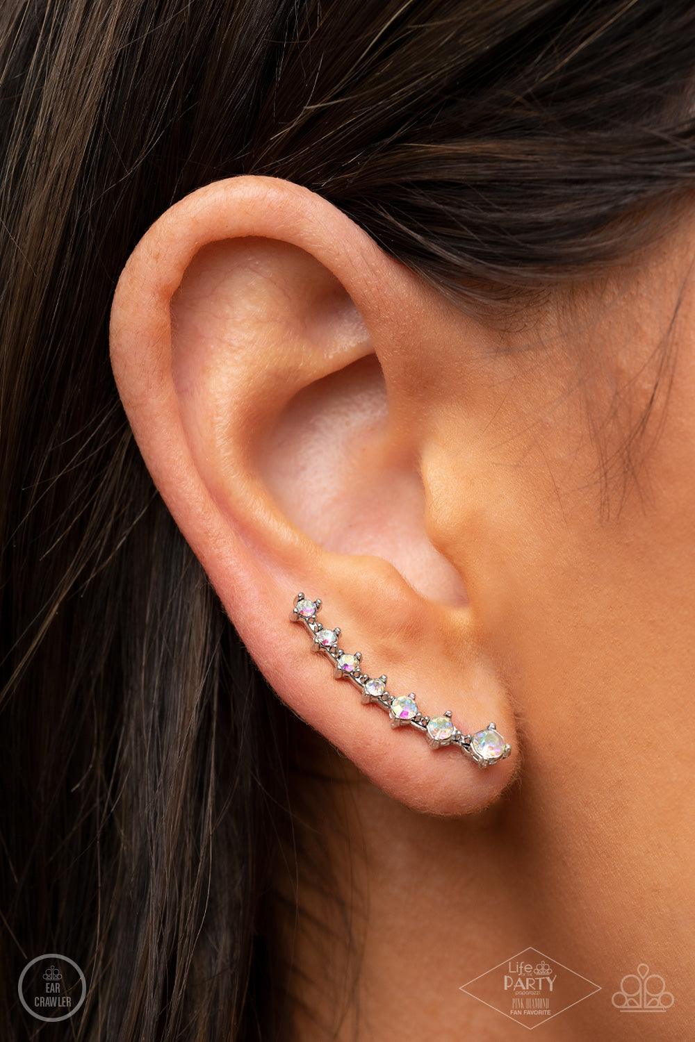 Paparazzi Accessories New Age Nebula - Multi Gradually decreasing in size, a dainty row of glittery iridescent rhinestones curve up the ear for a stellar chic look. Sold as one pair of ear crawlers. Earrings