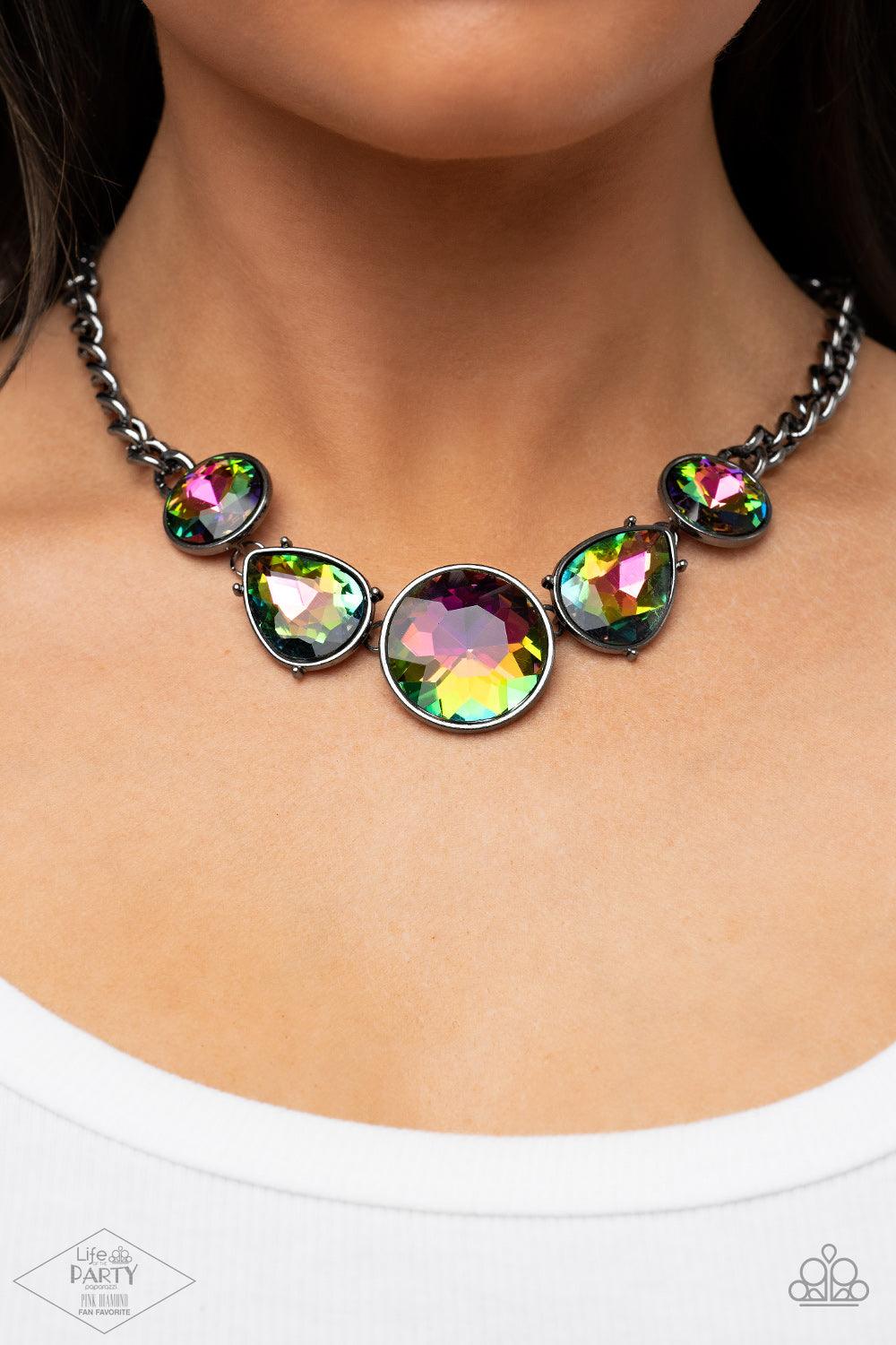 Paparazzi Accessories All The Worlds My Stage - Multi Infused with heavy gunmetal chain, an exaggerated display of round and teardrop-shaped oil spill rhinestones connects below the collar for a blinding look. Features an adjustable clasp closure. Sold as