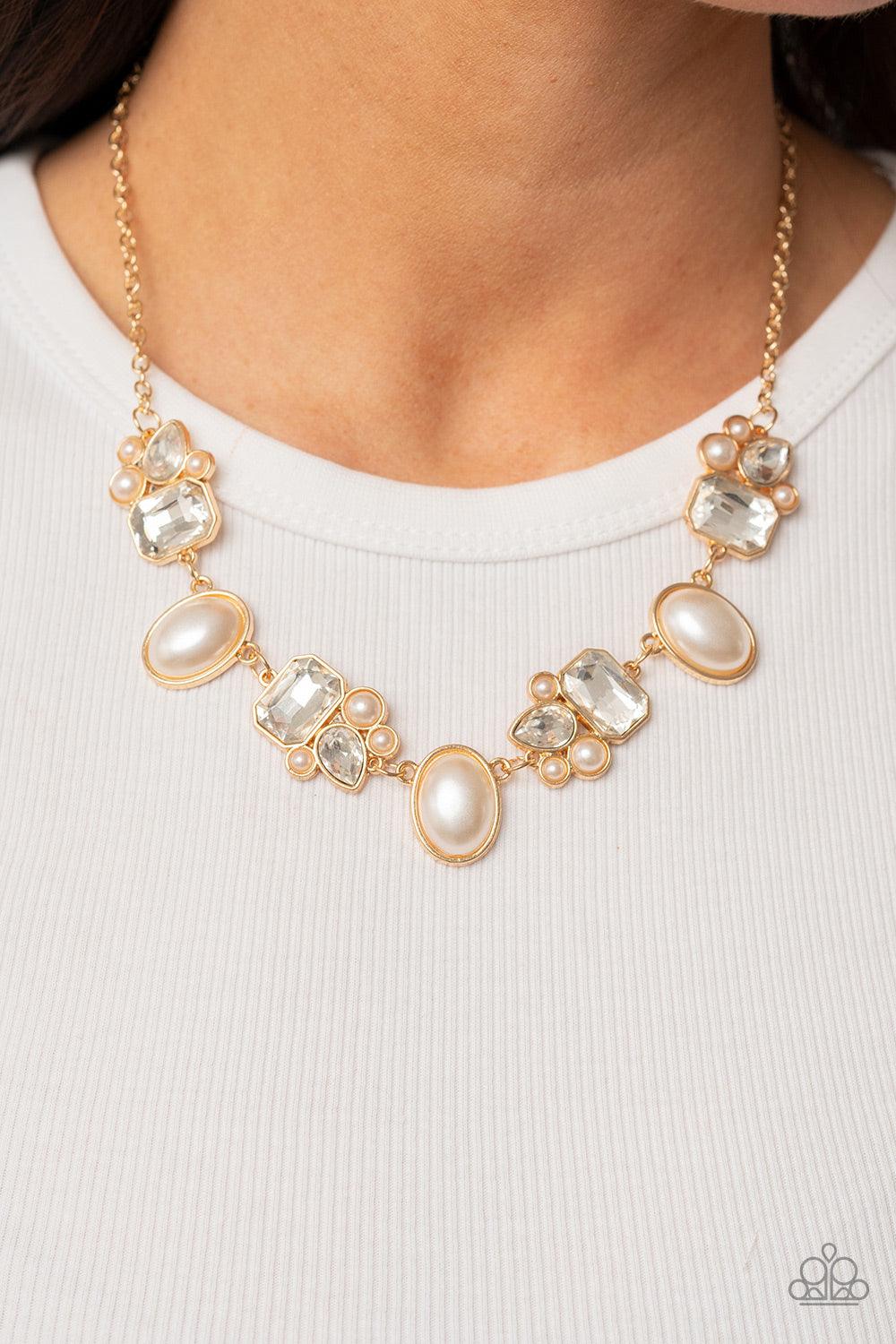 Paparazzi Accessories Sensational Showstopper - Gold Swoon-worthy emerald cut and teardrop rhinestones, accented with bubbly pearl beads, coalesce into stunning asymmetrical gold frames. A trio of elegant white oval pearl beads alternates with the asymmet