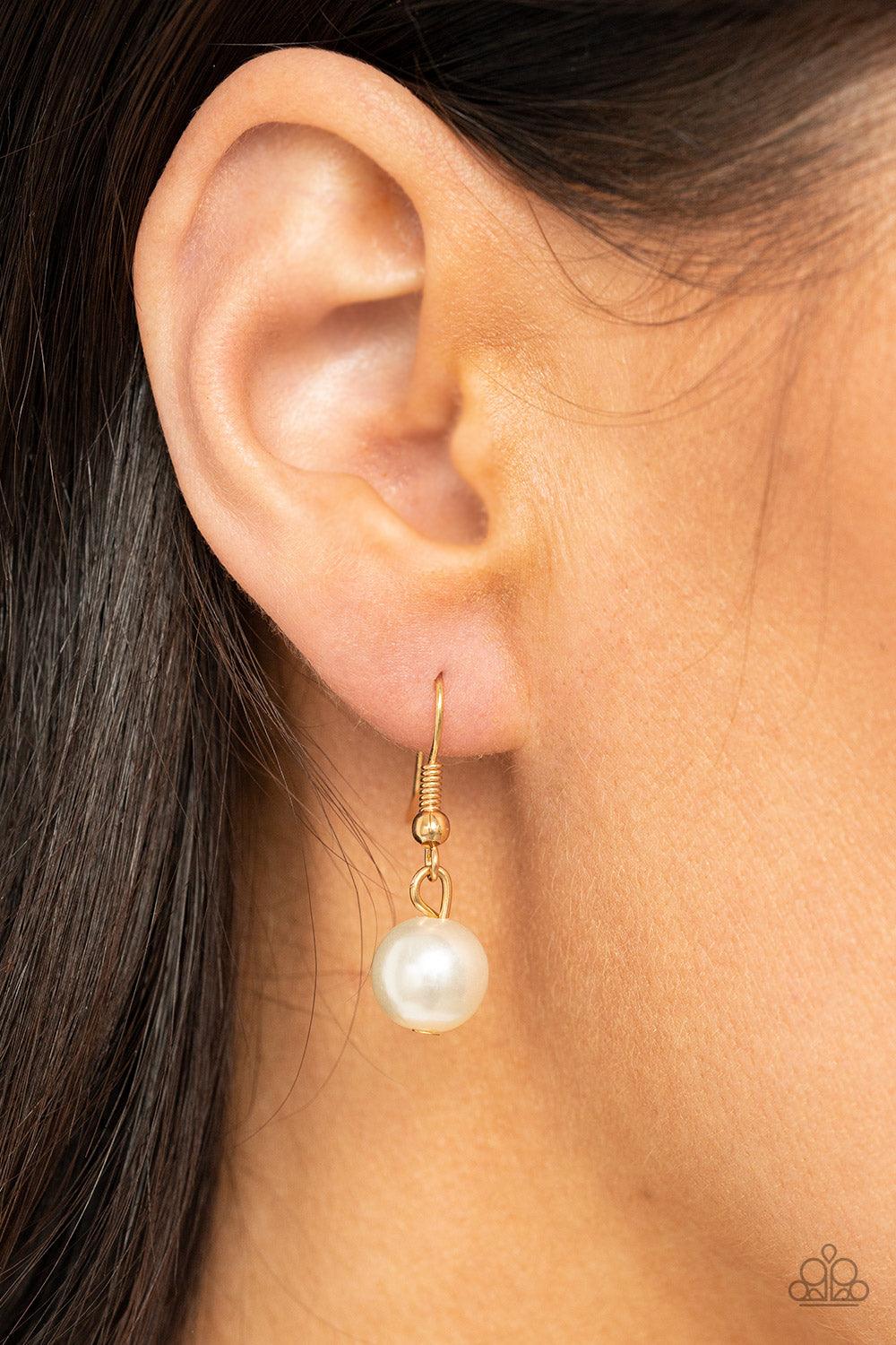 Paparazzi Accessories Sensational Showstopper - Gold Swoon-worthy emerald cut and teardrop rhinestones, accented with bubbly pearl beads, coalesce into stunning asymmetrical gold frames. A trio of elegant white oval pearl beads alternates with the asymmet