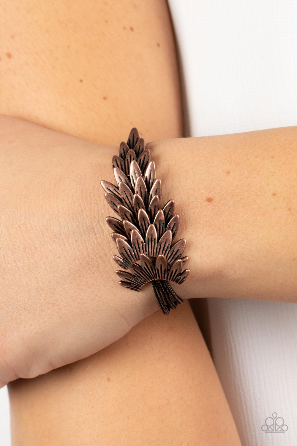 Paparazzi Accessories BOA and Arrow - Copper Feathery copper frames delicately overlap across the center of the wrist, creating a boa-like centerpiece atop rows of rustic copper chains. Features an adjustable clasp closure. Sold as one individual bracelet