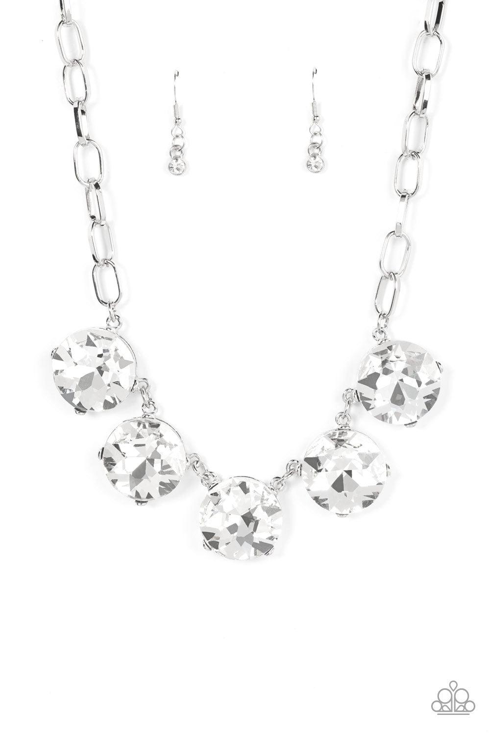Paparazzi Accessories Limelight Luxury - White Set in silver pronged fittings, five dramatically oversized brilliant white rhinestones connect across the collar and attach to an oversized silver chain creating a stunning spot-light loving statement piece.