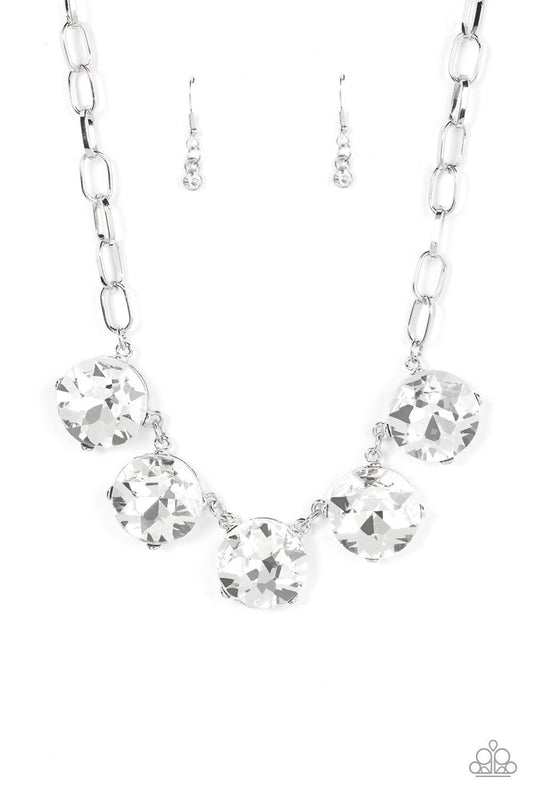 Paparazzi Accessories Limelight Luxury - White Set in silver pronged fittings, five dramatically oversized brilliant white rhinestones connect across the collar and attach to an oversized silver chain creating a stunning spot-light loving statement piece.