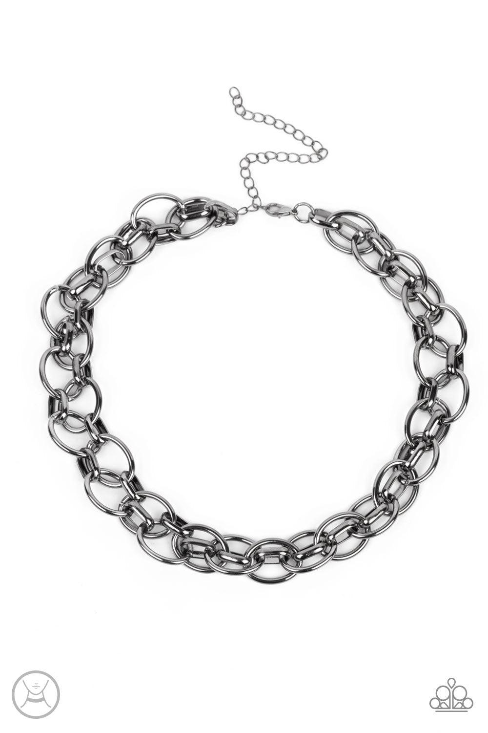 Paparazzi Accessories Tough Crowd - Black An oversized gunmetal chain interlocks with an oval linked chain, resulting in a rebellious fashion around the neck. Features an adjustable clasp closure. Sold as one individual choker necklace. Includes one pair