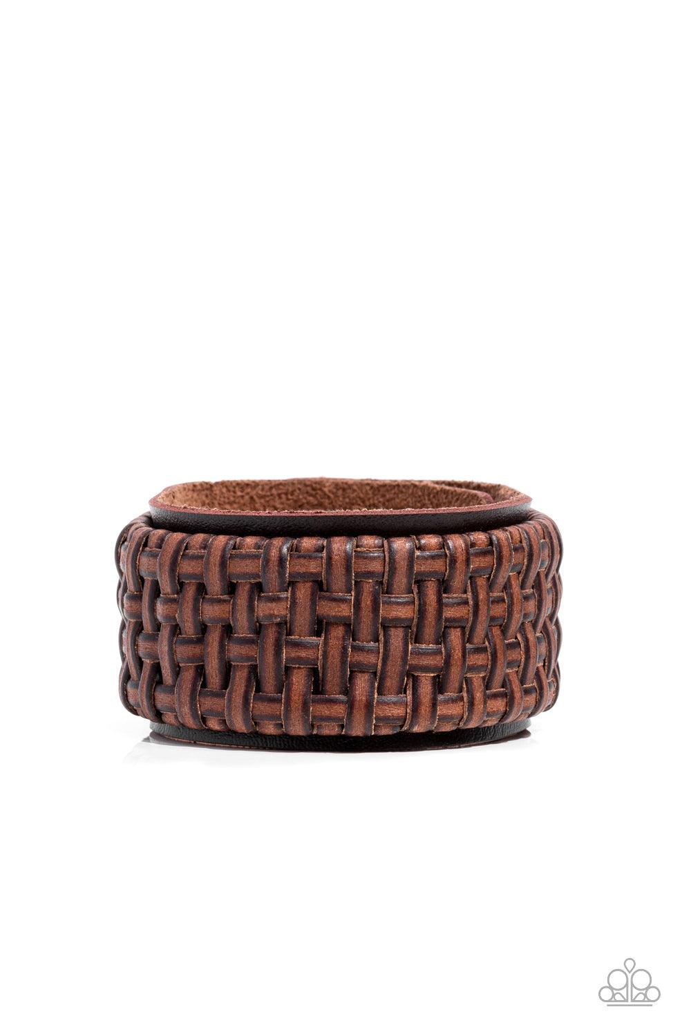 Paparazzi Accessories Urban Expansion - Brown Distressed leather laces weave into a wicker-like pattern, creating a thick band of texture that wraps around a leather band. The textured overlay is studded in place across the front of the brown leather band