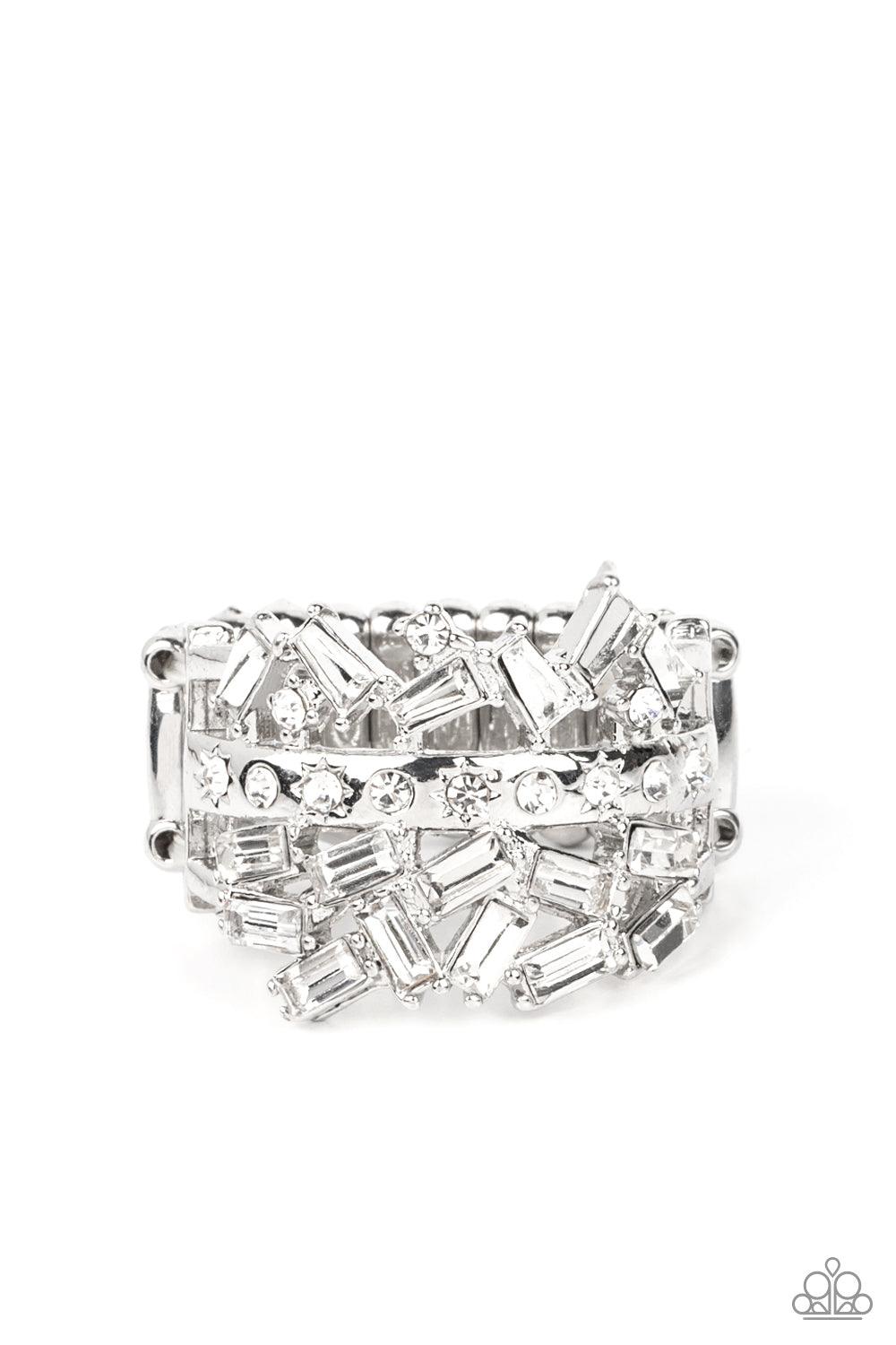 Paparazzi Accessories Scattered Sensation - White Dotted in dainty white rhinestones, a single silver band separates a haphazard explosion of round and emerald cut rhinestones across the finger. Features a stretchy band for a flexible fit. Sold as one ind