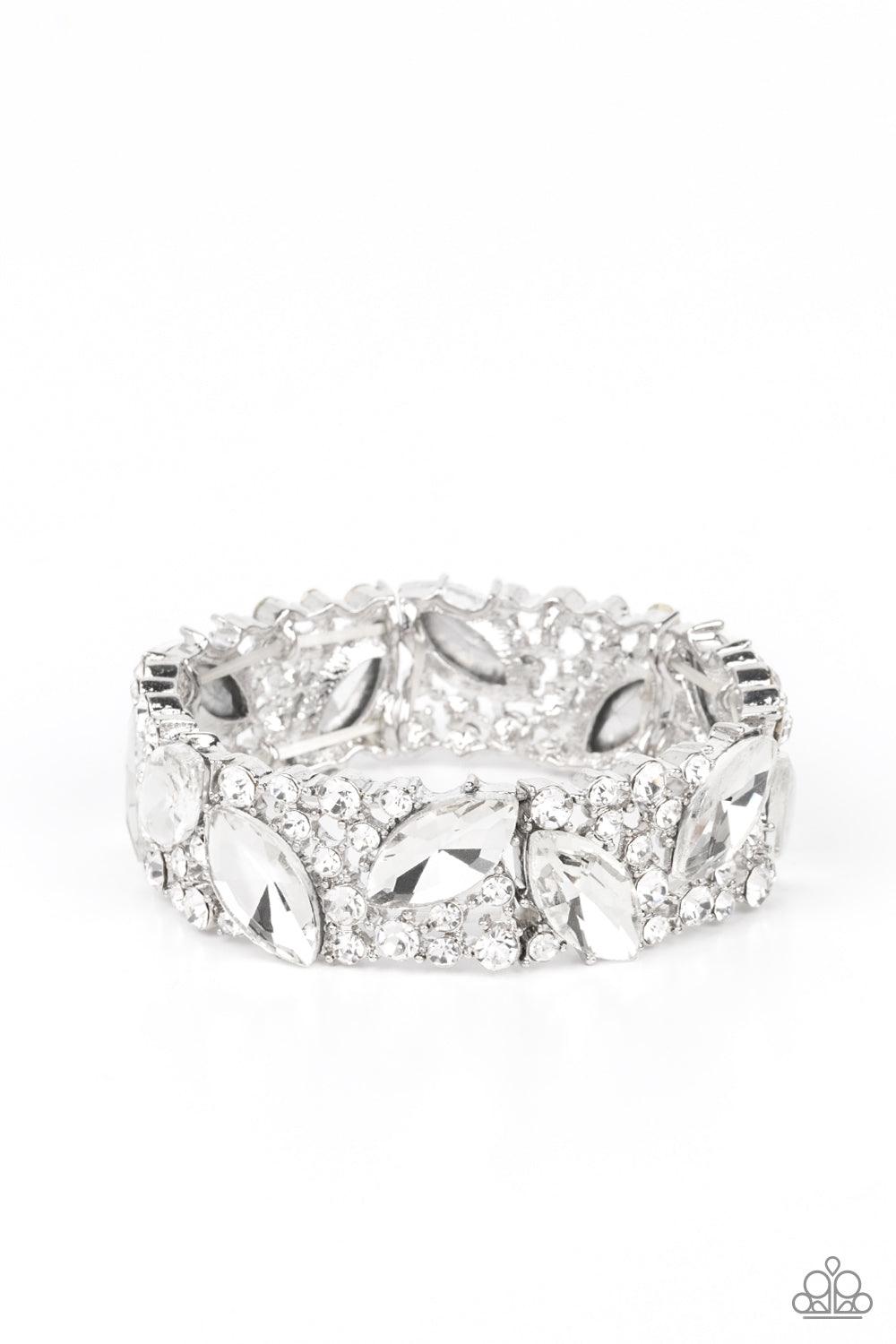 Paparazzi Accessories Full Body Chills - White Oversized marquise cut white rhinestones sparkle atop icy frames of dainty silver studs and white rhinestones that are threaded along stretchy bands around the wrist for a jaw-dropping dazzle. Sold as one ind