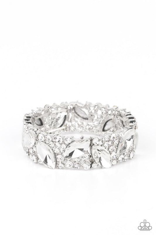 Paparazzi Accessories Full Body Chills - White Oversized marquise cut white rhinestones sparkle atop icy frames of dainty silver studs and white rhinestones that are threaded along stretchy bands around the wrist for a jaw-dropping dazzle. Sold as one ind