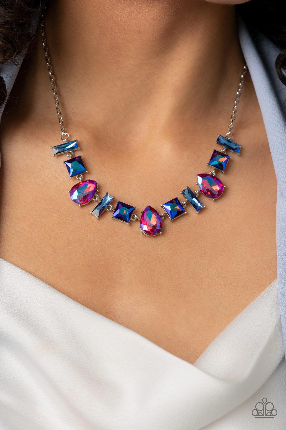 Paparazzi Accessories Interstellar Ice - Pink Featuring glassy, iridescent, and oil spill finishes, a mismatched collection of emerald cut blue, square multicolored, and teardrop pink gems delicately connects below the collar for a stellar statement. Feat