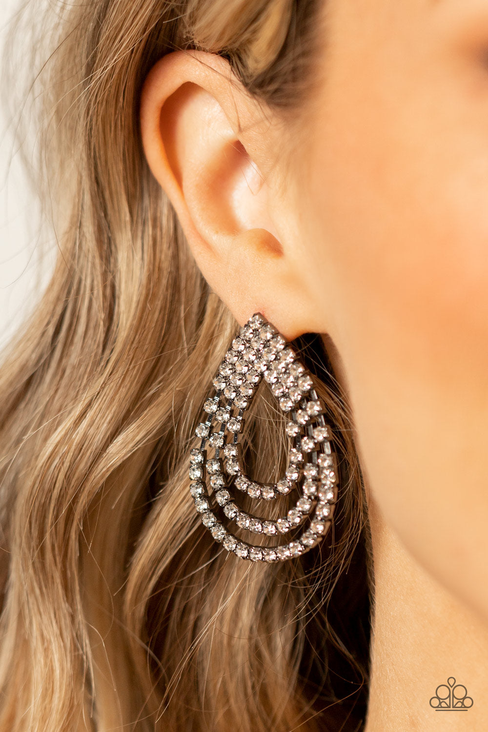 Paparazzi Accessories Take a POWER Stance - Black Loops of glassy white rhinestones ripple out from the bottom of a stationary triangular fitting that is dotted in glittery white rhinestones, resulting in a timeless teardrop chandelier. Earring attaches t