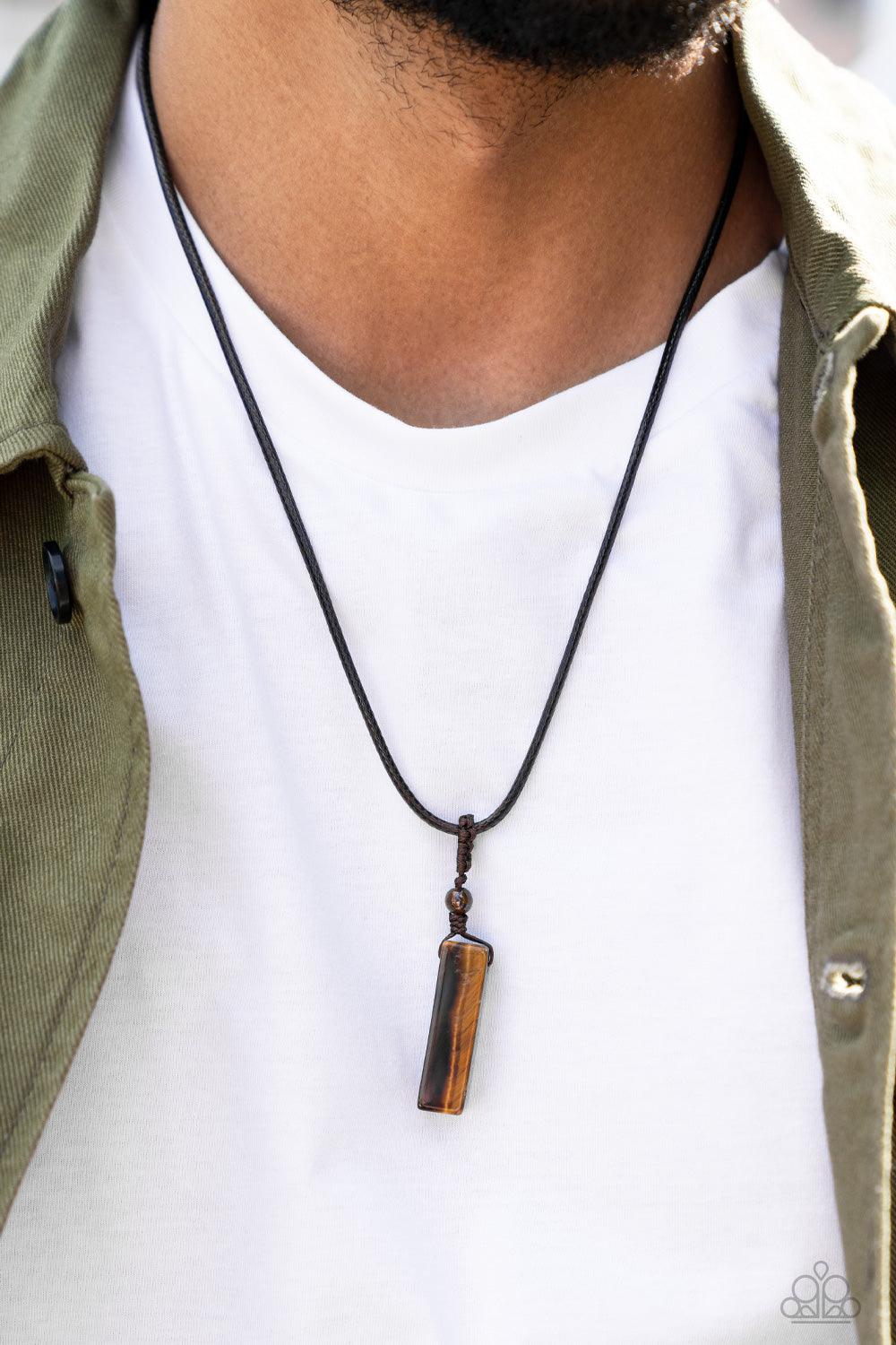 Paparazzi Accessories Comes Back ZEN-fold - Brown A rectangular tiger's eye stone pendulum is knotted in place below a dainty tiger's eye stone bead that glides along a shiny brown cord below the collar, resulting in an earthy pendant. Features an adjusta