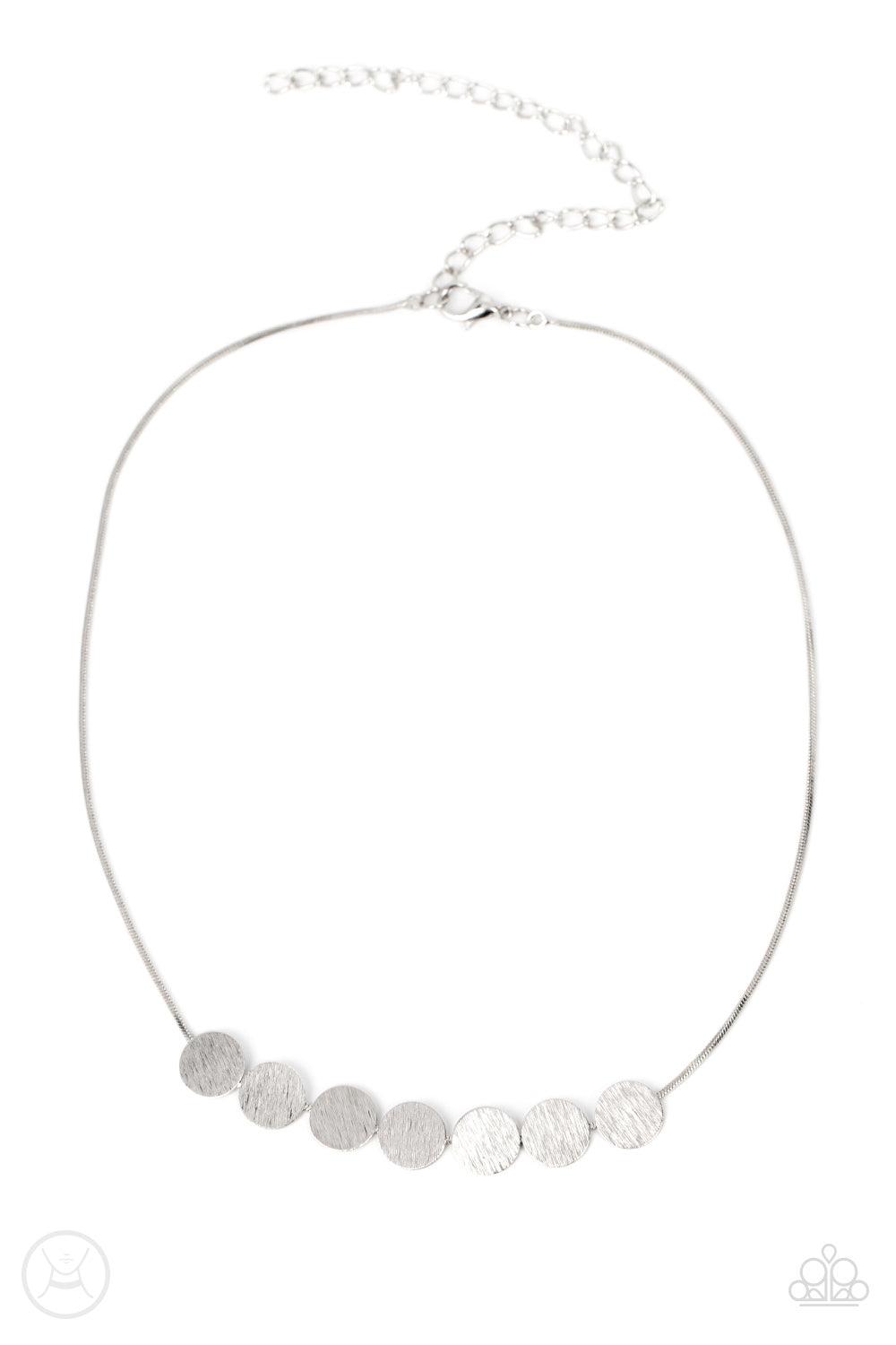 Paparazzi Accessories Slimmer Glimmer - Silver Featuring shimmery scratched surfaces, a glimmering collection of dainty silver discs are fitted in place along a silver snake chain around the neck for a sleek finish. Features an adjustable clasp closure. S