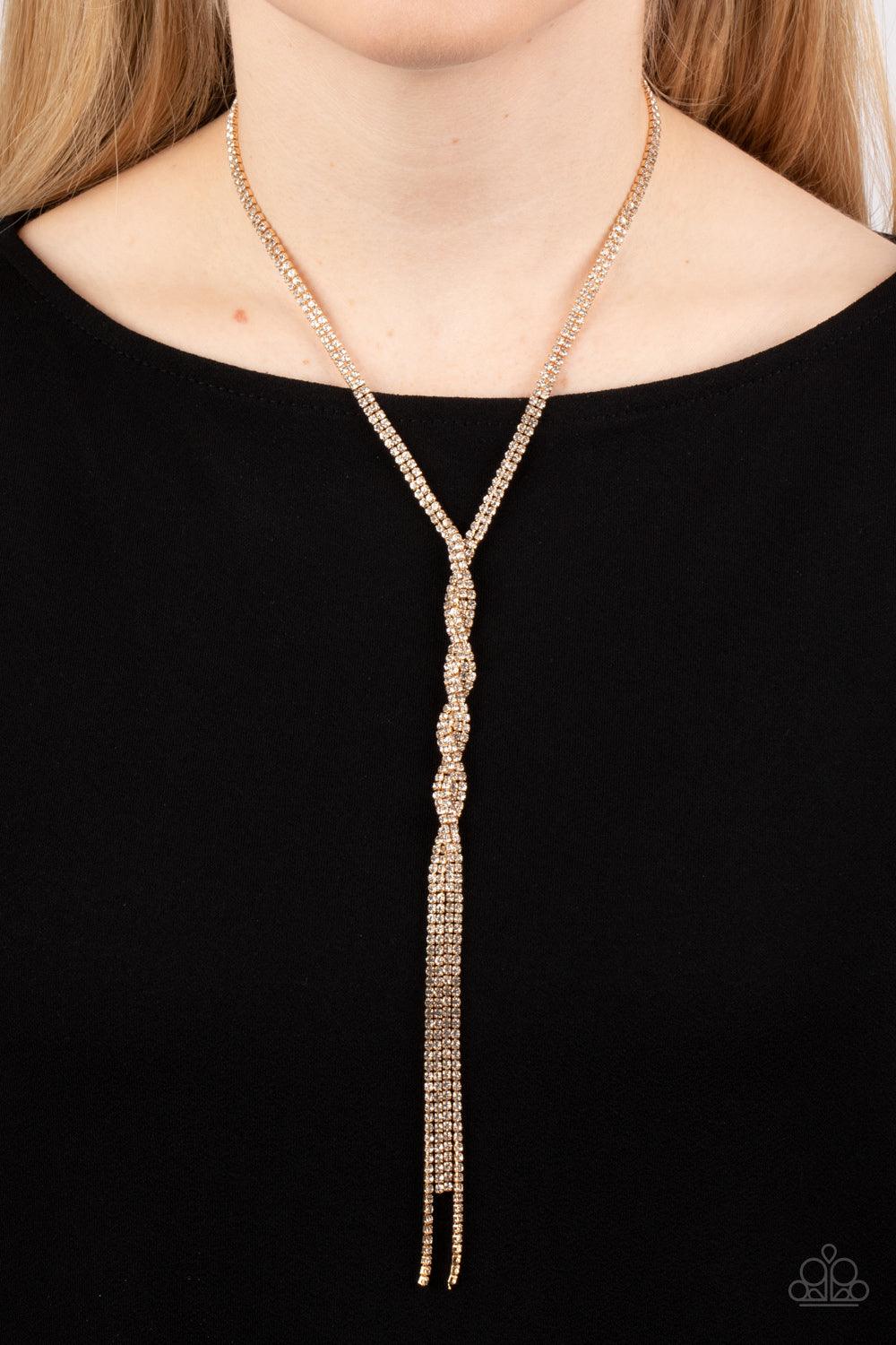 Paparazzi Accessories Impressively Icy - Gold Golden ribbons of glassy white rhinestones loop around the neck and delicately twist into an icy tassel down the chest. Features an adjustable clasp closure. Sold as one individual necklace. Includes one pair