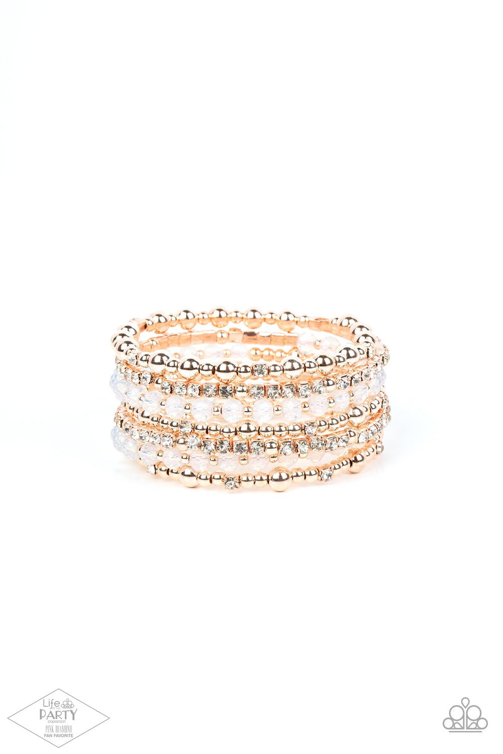 Paparazzi Accessories ICE Knowing You - Rose Gold An icy collection of rose gold beads, rose gold cubes, opaque crystals, and glassy white rhinestones are threaded along a coiled wire, creating a blinding infinity wrap style bracelet around the wrist. Sol