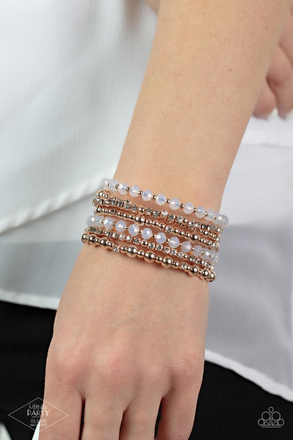 Paparazzi Accessories ICE Knowing You - Rose Gold An icy collection of rose gold beads, rose gold cubes, opaque crystals, and glassy white rhinestones are threaded along a coiled wire, creating a blinding infinity wrap style bracelet around the wrist. Sol
