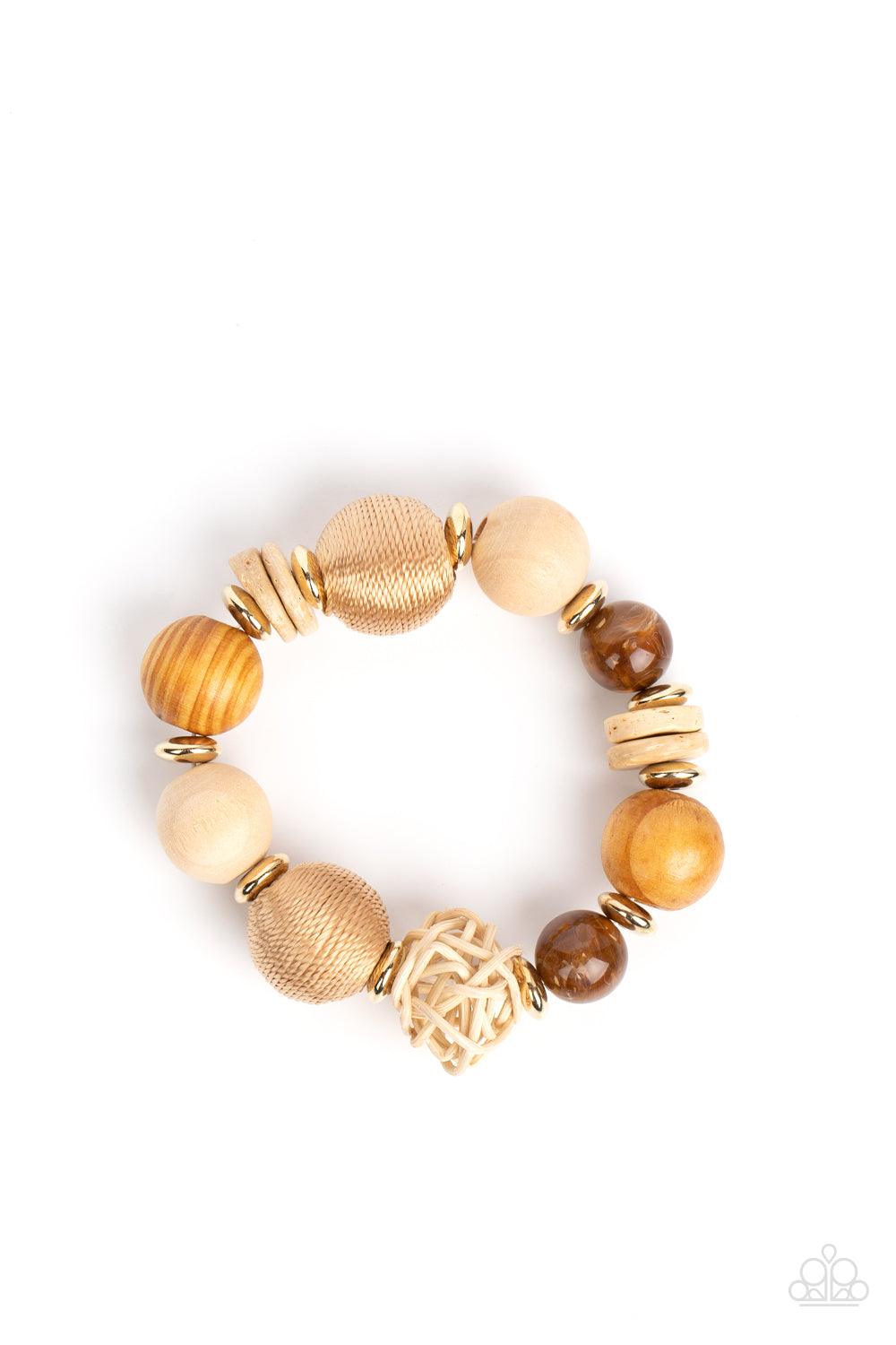 Paparazzi Accessories Happily Homespun - Brown Infused with a single rattan sphere, a mismatched collection of oversized wooden beads, tan thread wrapped beads, dainty gold accents, and glassy brown beads are threaded along stretchy bands around the wrist