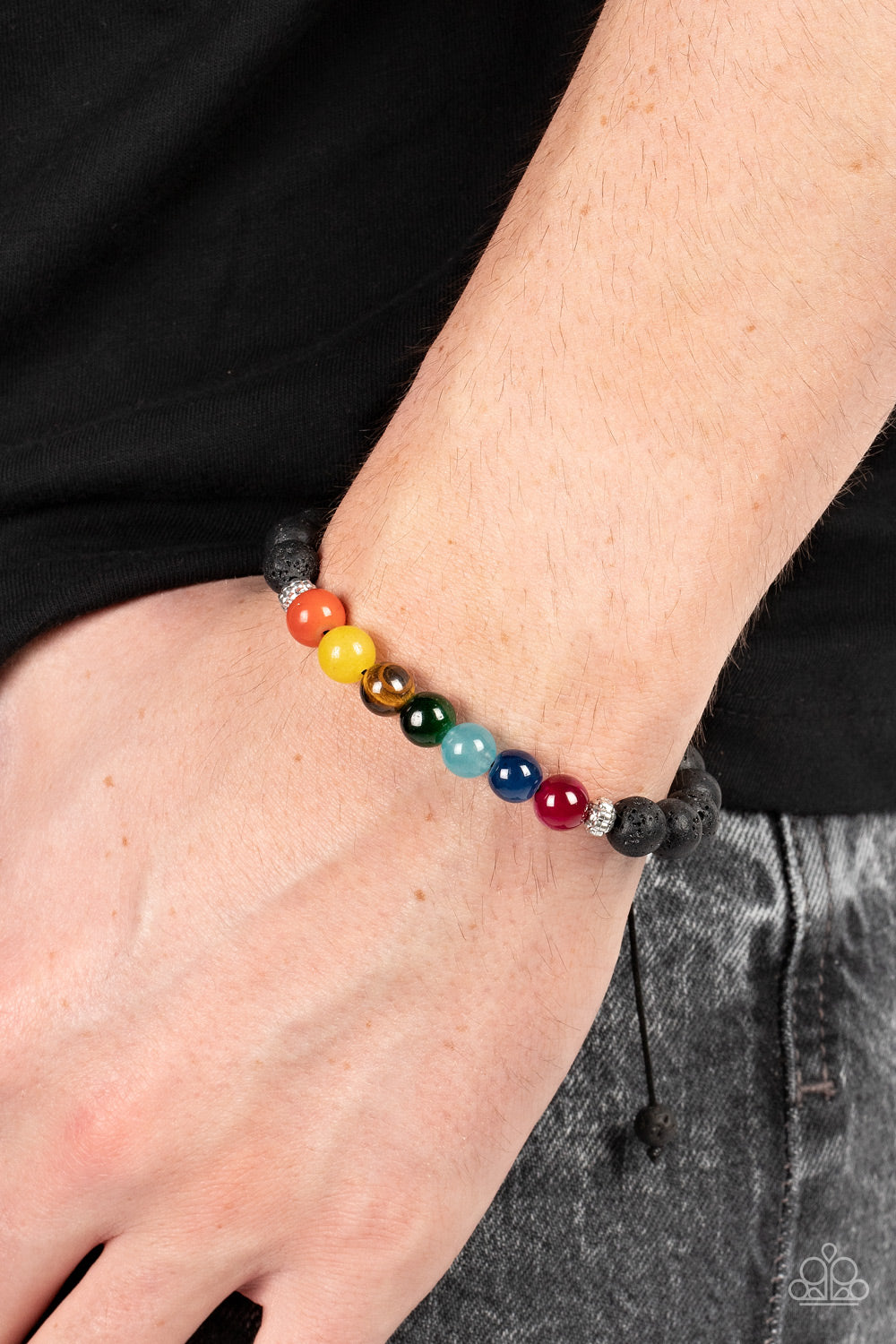 Paparazzi Accessories Canyon Kaleidoscope - Multi A pair of textured silver accents flanks a rainbow of glassy stone beads along a black lava rock beaded cord, resulting in a rustic pop of color around the wrist. Features an adjustable sliding knot closur