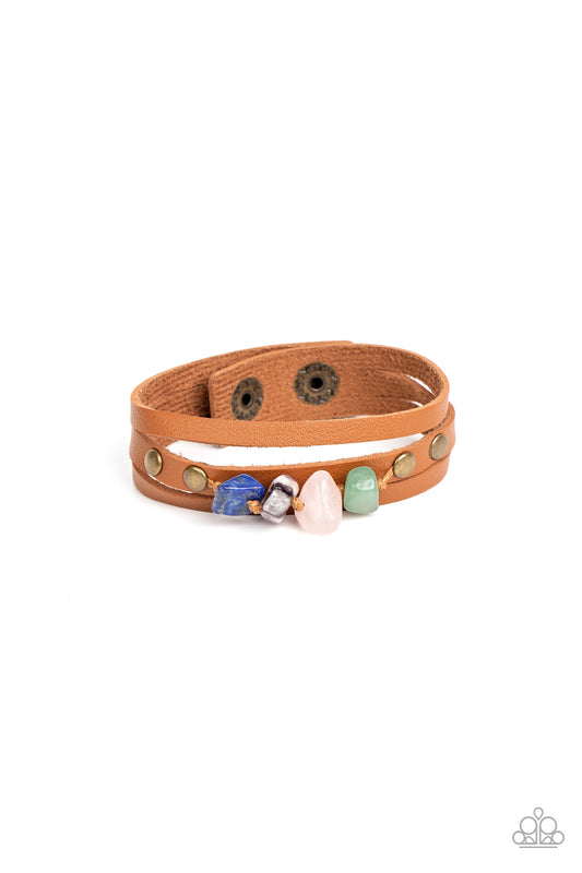 Paparazzi Accessories Creek Cache - Brass Chunks of jade, rose quartz, amethyst, and lapis lazuli stones are threaded along a knotted cord that is studded in place along the center band of a layered leather bracelet for a seasonal finish. Features an adju