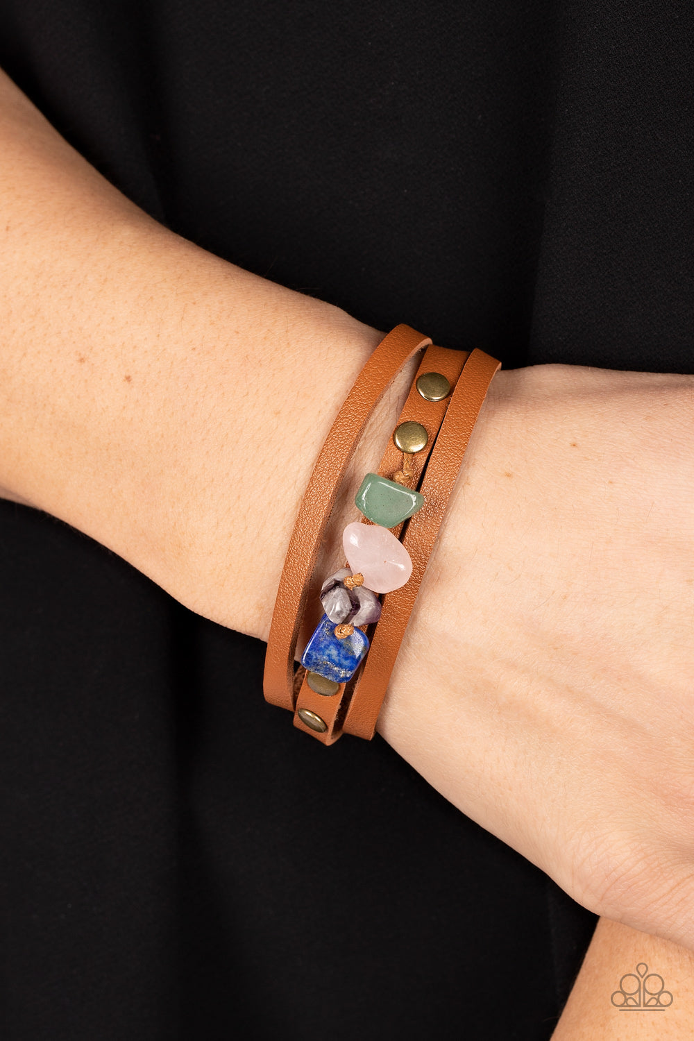 Paparazzi Accessories Creek Cache - Brass Chunks of jade, rose quartz, amethyst, and lapis lazuli stones are threaded along a knotted cord that is studded in place along the center band of a layered leather bracelet for a seasonal finish. Features an adju