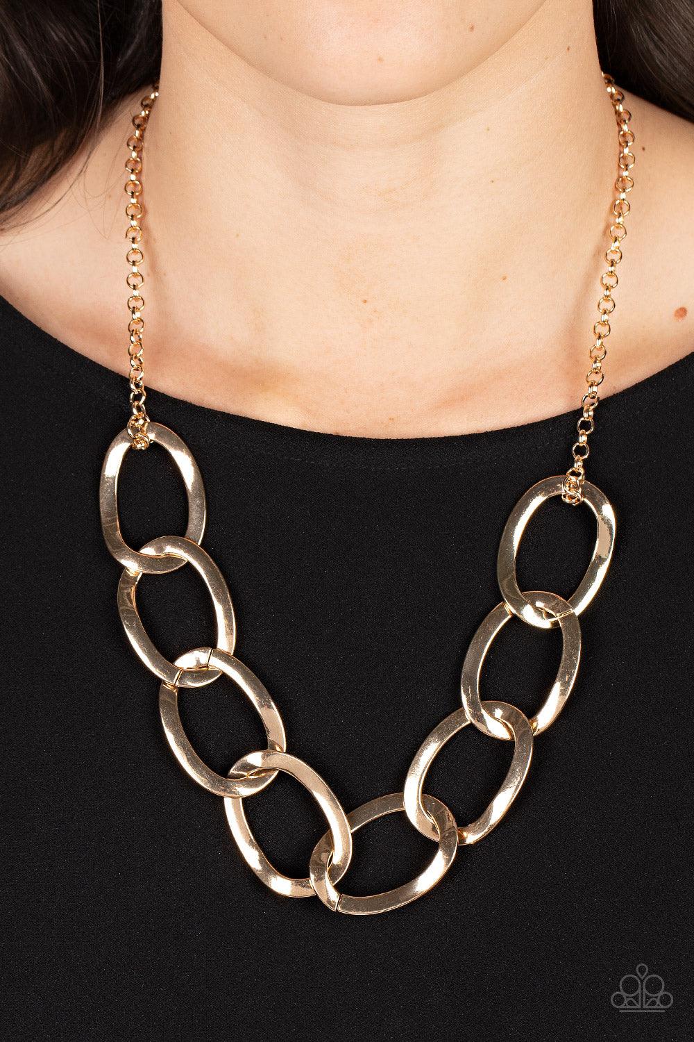 Paparazzi Accessories I've got the Power - Gold Attached to a classic gold chain, an oversized collection of warped oval links boldly interlocks below the collar for an intense industrial look. Features an adjustable clasp closure. Sold as one individual