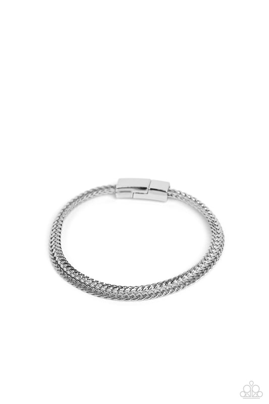 Paparazzi Accessories Cable Train - Silver Intricate silver chains interlock into an edgy centerpiece around the wrist, resulting in a gritty statement piece. Features a magnetic closure. Sold as one individual bracelet. Jewelry