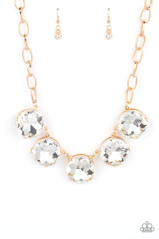 Paparazzi Accessories Limelight Luxury - Gold Set in gold pronged fittings, five dramatically oversized white rhinestones connect across the collar and attach to an oversized gold chain creating a stunning spot-light loving statement piece. Features an ad