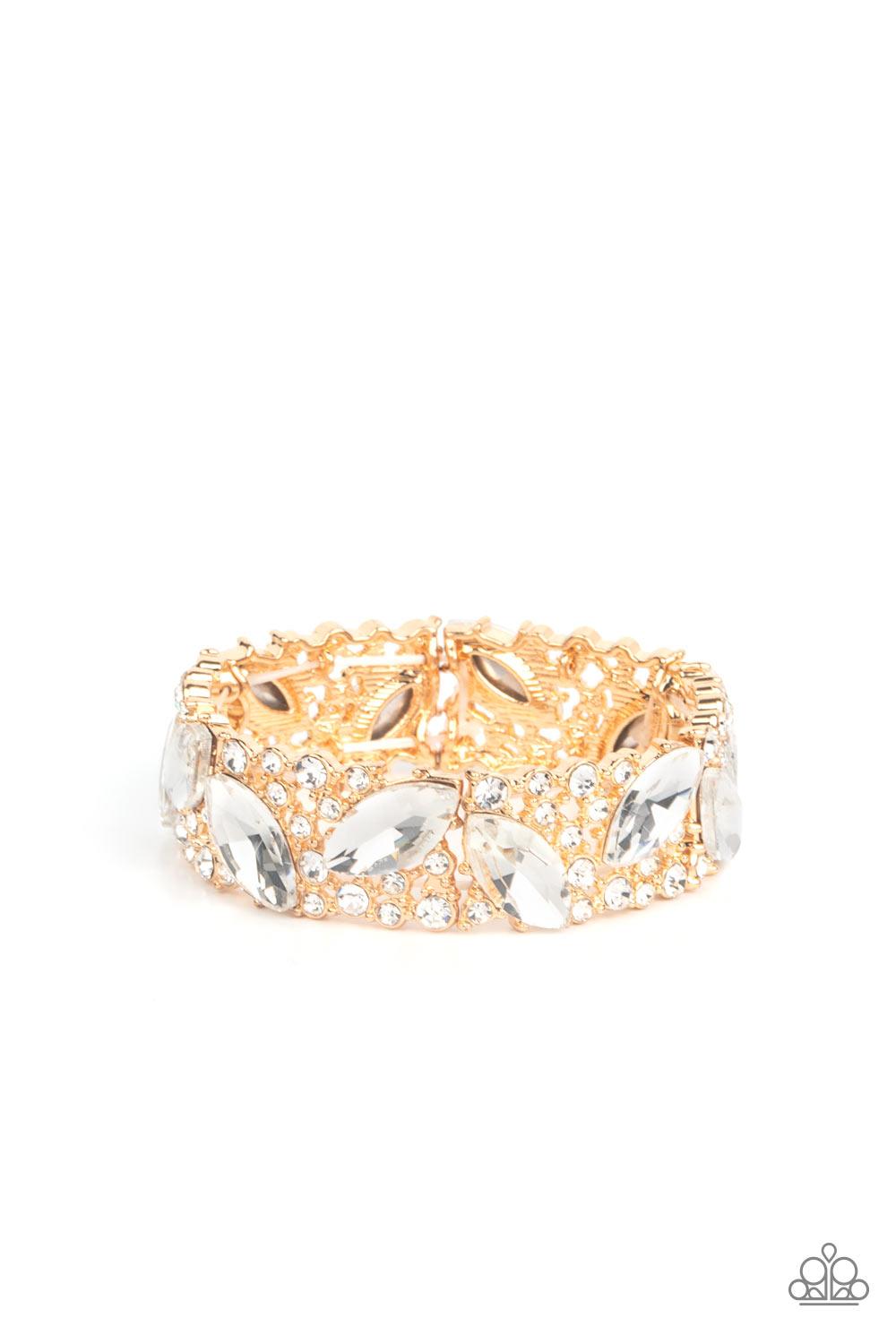 Paparazzi Accessories Full Body Chills - Gold Oversized marquise cut white rhinestones sparkle atop icy frames of dainty gold studs and white rhinestones that are threaded along stretchy bands around the wrist for a jaw-dropping dazzle. Sold as one indivi