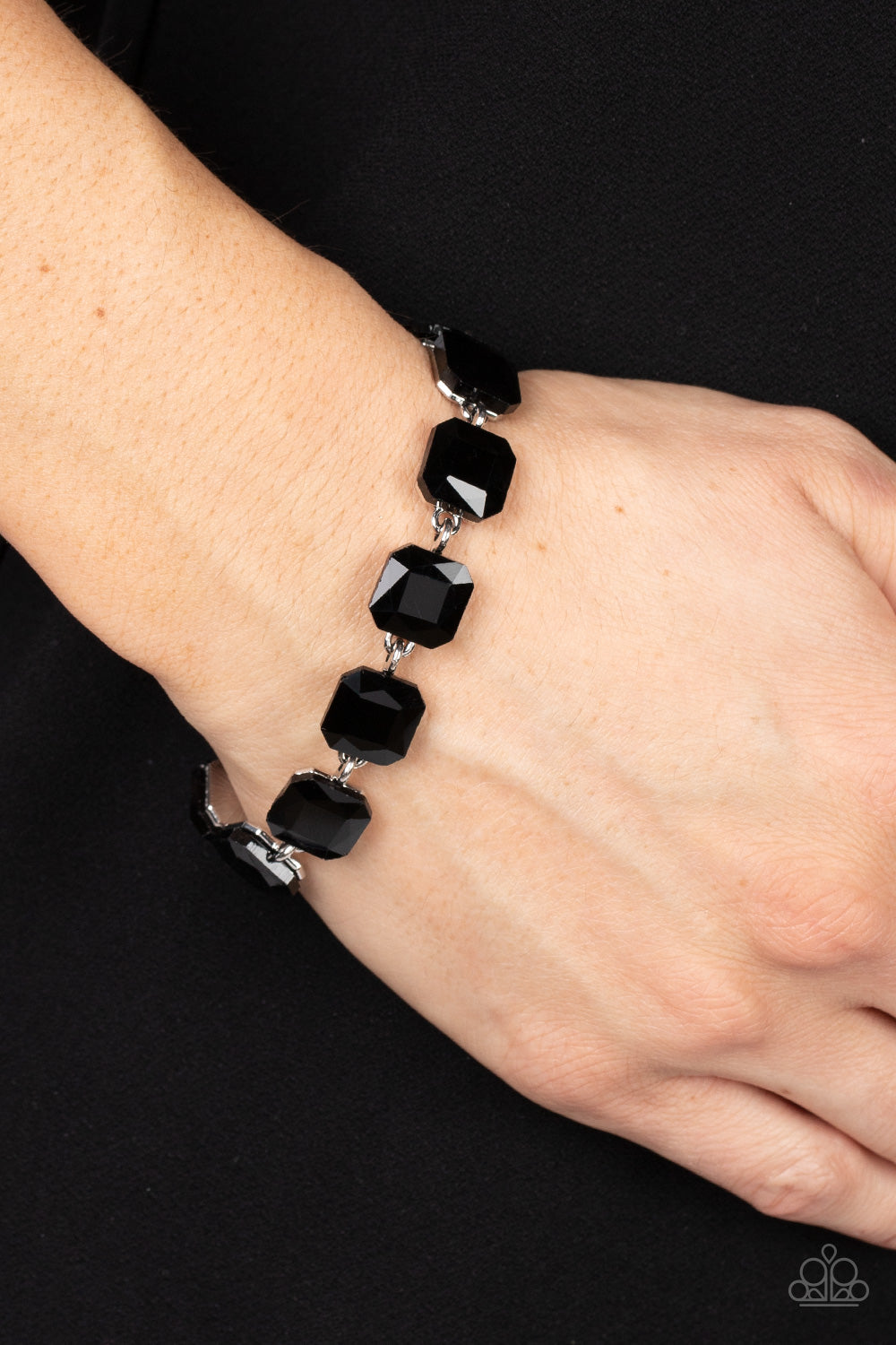 Paparazzi Accessories Mind-Blowing Bling - Black Featuring radiant cuts, glittery black rhinestones sit atop silver frames as they delicately link around the wrist for a mind-blowing brilliance. Features an adjustable clasp closure. Sold as one individual