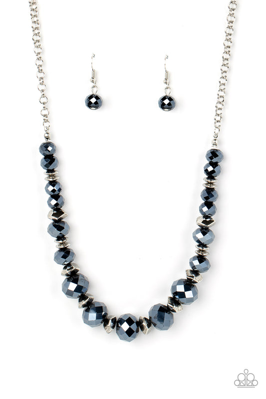 Paparazzi Accessories Cosmic Cadence - Blue Separated by silver discs and faceted silver accents, faceted blue crystal-like gems are threaded along an invisible wire below the collar for a stellar statement. Features an adjustable clasp closure. Sold as o