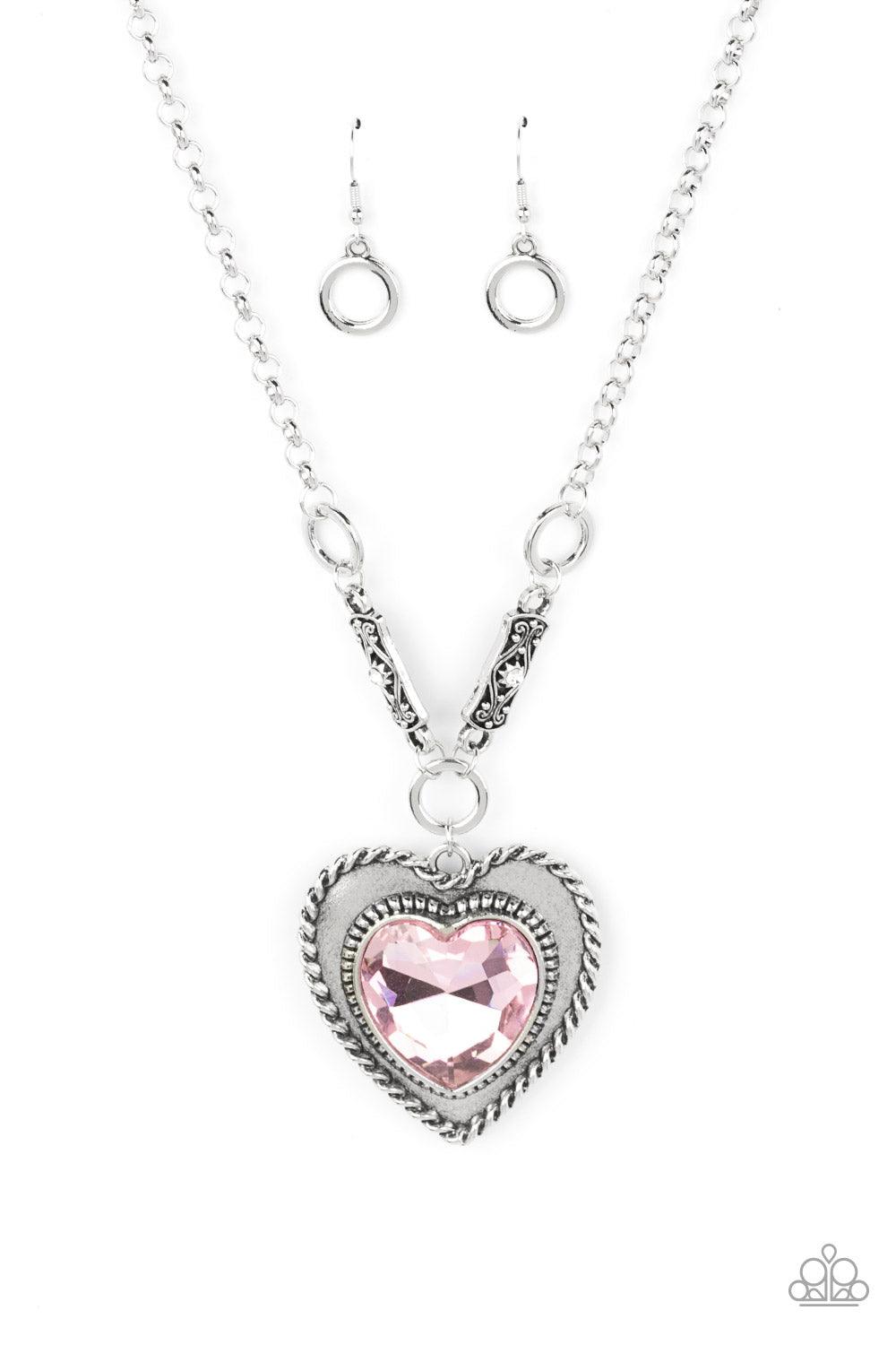 Paparazzi Accessories Heart Full of Fabulous - Pink Bordered in spun silver ribbons, an oversized Gossamer Pink heart gem is pressed into a silver heart frame below the collar. The flirtatious pendant attaches to silver rings and decorative silver frames