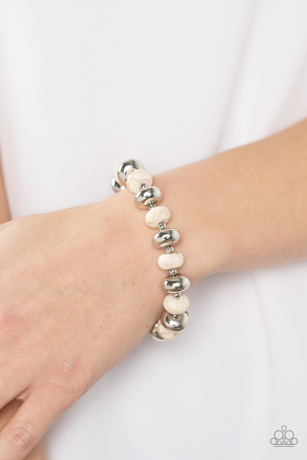 Paparazzi Accessories Stone Age Aesthetic - White Separated by dainty silver beads, rounded silver accents and white stone beads alternate along a stretchy band around the wrist for an adventurous pop of artisan inspired color. Sold as one individual brac