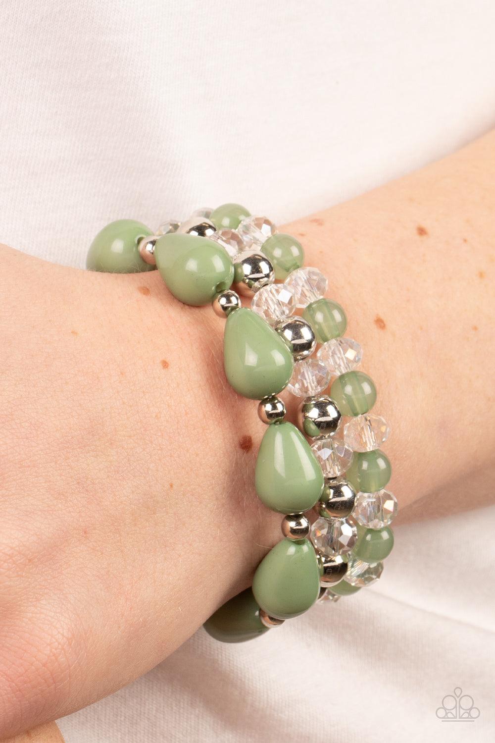 Paparazzi Accessories Beachside Brunch - Green A whimsical assortment of crystal-like beads, silver beads, opaque Basil beads, and Basil teardrop beads are threaded along stretchy bands around the wrist, resulting in colorful layers. Sold as one set of th