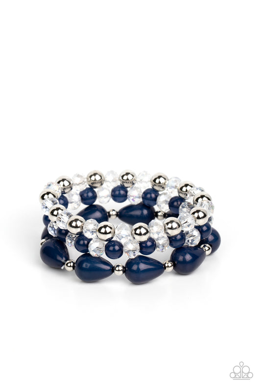 Paparazzi Accessories Beachside Brunch - Blue A whimsical assortment of crystal-like beads, silver beads, opaque navy beads, and navy teardrop beads are threaded along stretchy bands around the wrist, resulting in colorful layers. Sold as one set of three