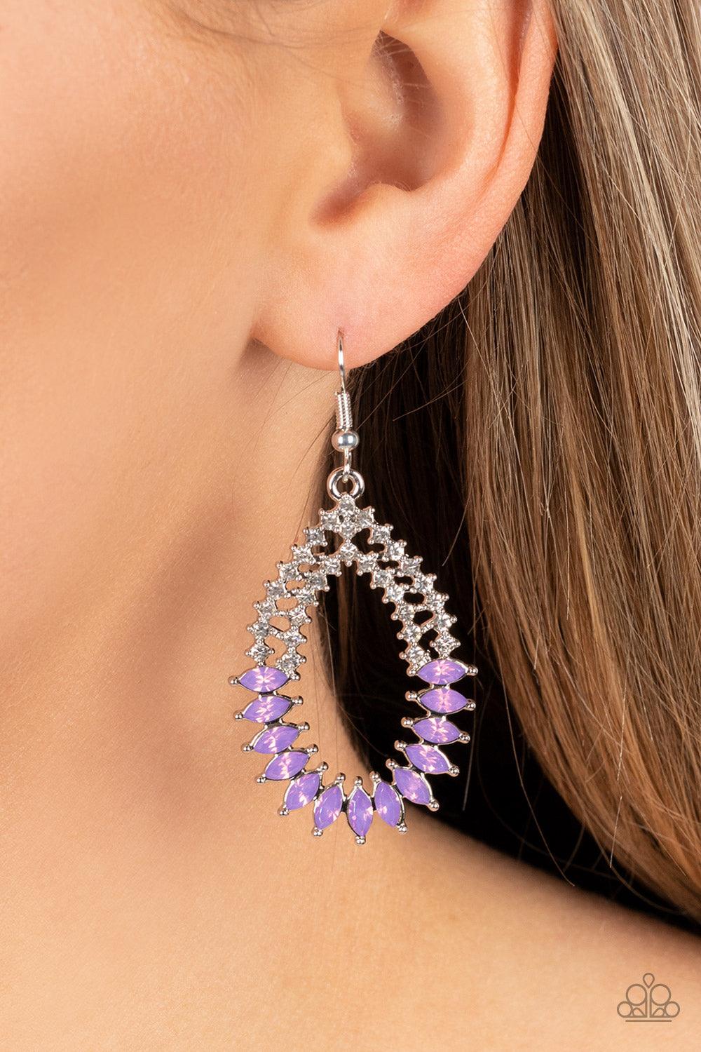 Paparazzi Accessories Lucid Luster - Purple Encased in pronged silver fittings, marquise cut opaque purple gems twinkle at the bottom of two dainty rows of glassy white rhinestones that delicately arc into an ethereal teardrop frame. Earring attaches to a