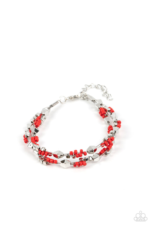 Paparazzi Accessories Elite Explorer - Red A dainty collection of faceted silver beads, red seed beads, and silver cubes are threaded along multiple strands of silver wire around the wrist, creating clustered layers. Features an adjustable clasp closure.