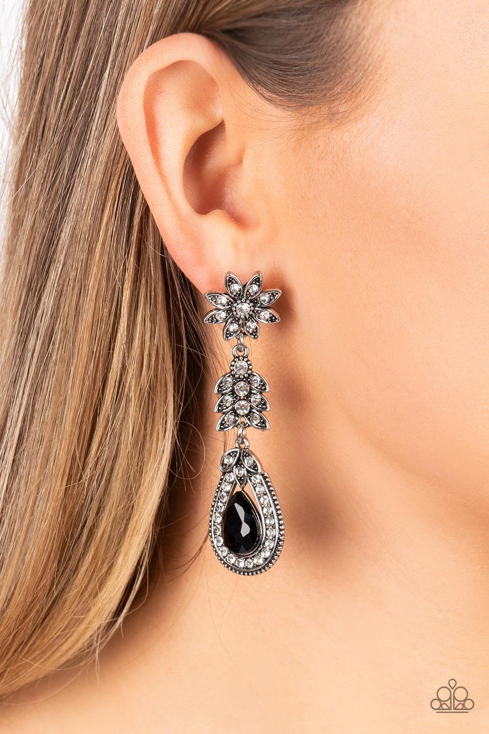 Paparazzi Accessories Floral Fantasy - Black Dotted in dainty white rhinestones, a studded silver flower gives way to a leafy frame that is delicately suspended above a decorative white rhinestone dotted teardrop frame. An oversized black teardrop gem see