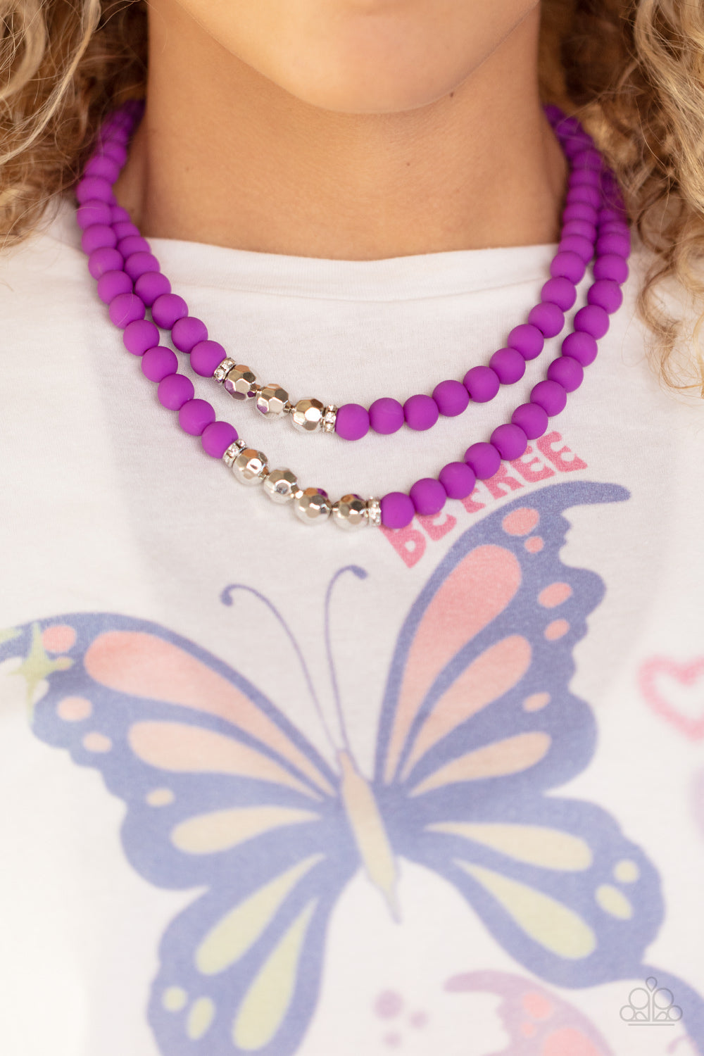 Paparazzi Accessories Summer Splash - Purple Threaded along invisible wires, matte-finished Dahlia beads give way to center sections of white rhinestone encrusted rings and faceted silver beads. The vivacious display layers below the collar, creating a su