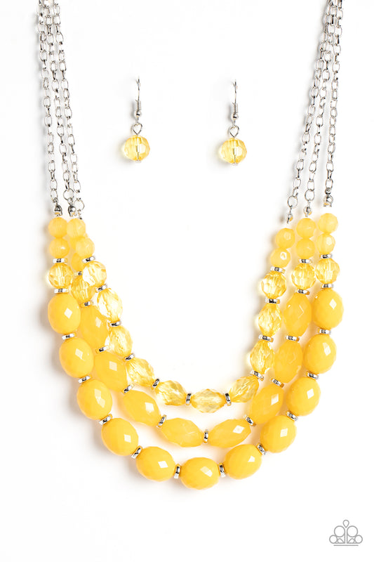 Paparazzi Accessories Tropical Hideaway - Yellow Separated by dainty silver rings, mismatched rows of glassy, opaque, and solid Daffodil acrylic crystal-like beads are threaded along invisible wires below the collar, creating vivacious layers. Features an