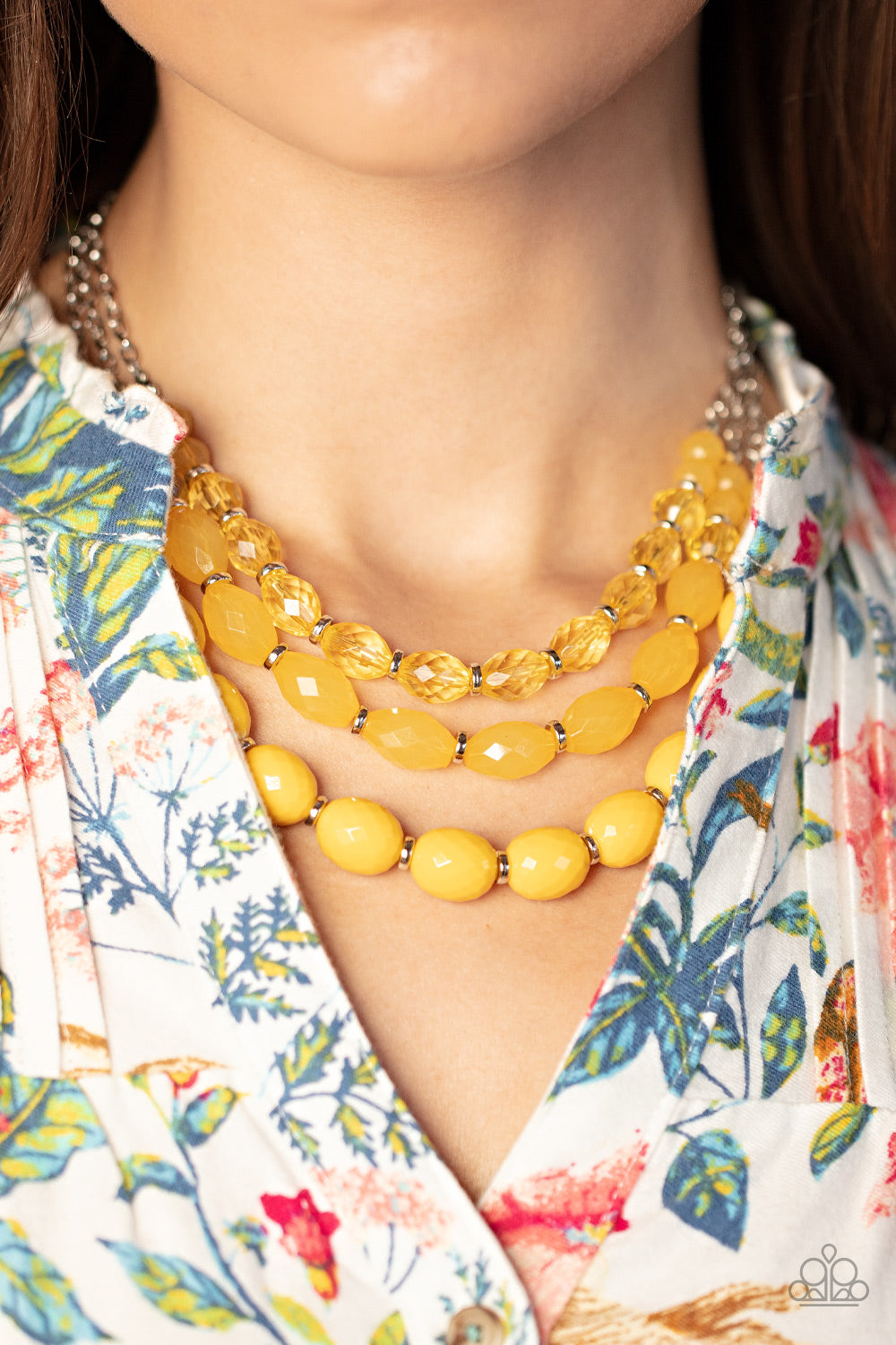 Paparazzi Accessories Tropical Hideaway - Yellow Separated by dainty silver rings, mismatched rows of glassy, opaque, and solid Daffodil acrylic crystal-like beads are threaded along invisible wires below the collar, creating vivacious layers. Features an